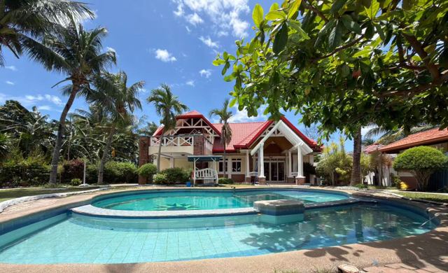 The resort and pool surrounded by palm trees